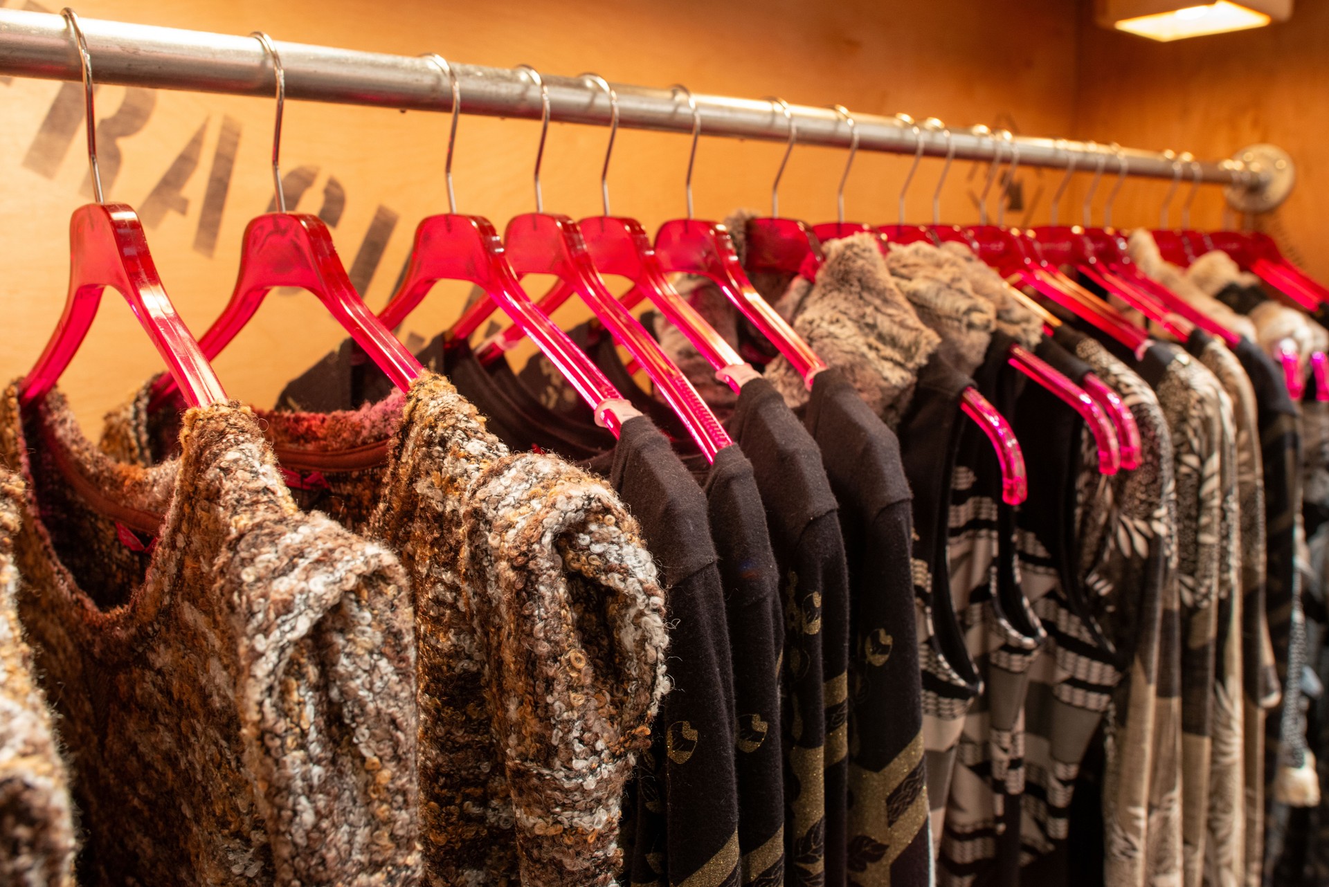 fancy designer clothing hanging at a boutique rack